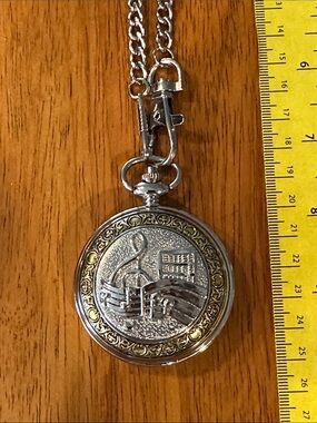 Shoppe Watch Men’s Musical Note Pocket Watch. 2” Two tone with white face.